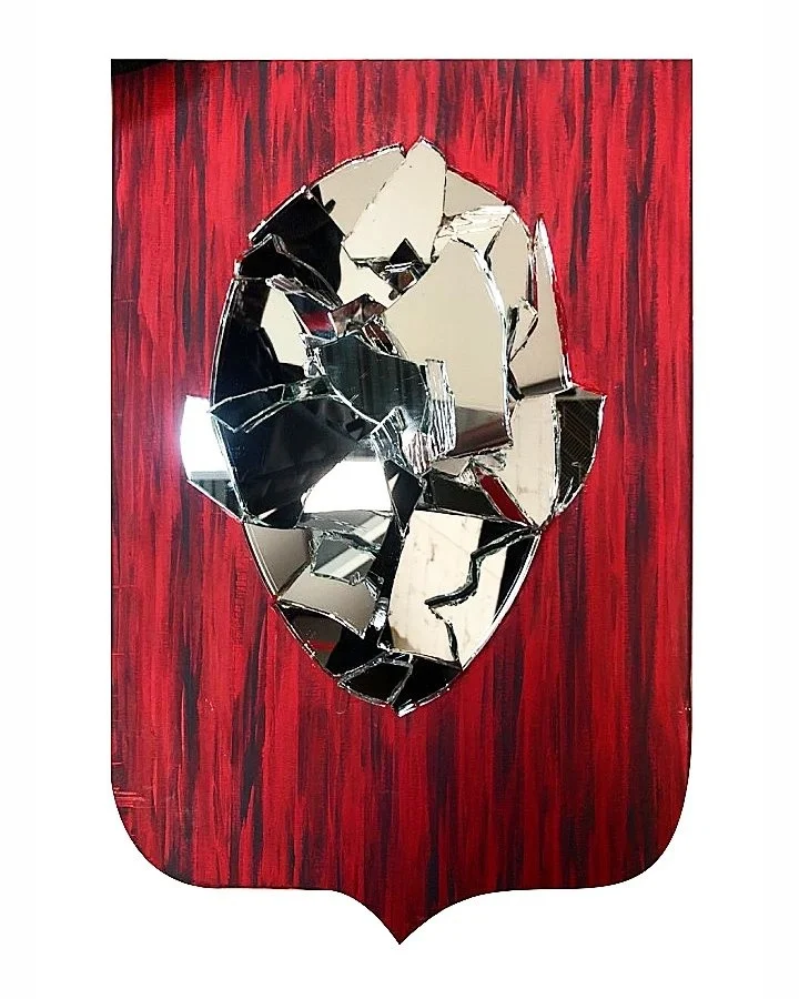 Farewell: a face made of broken mirror on a red shield-shaped board