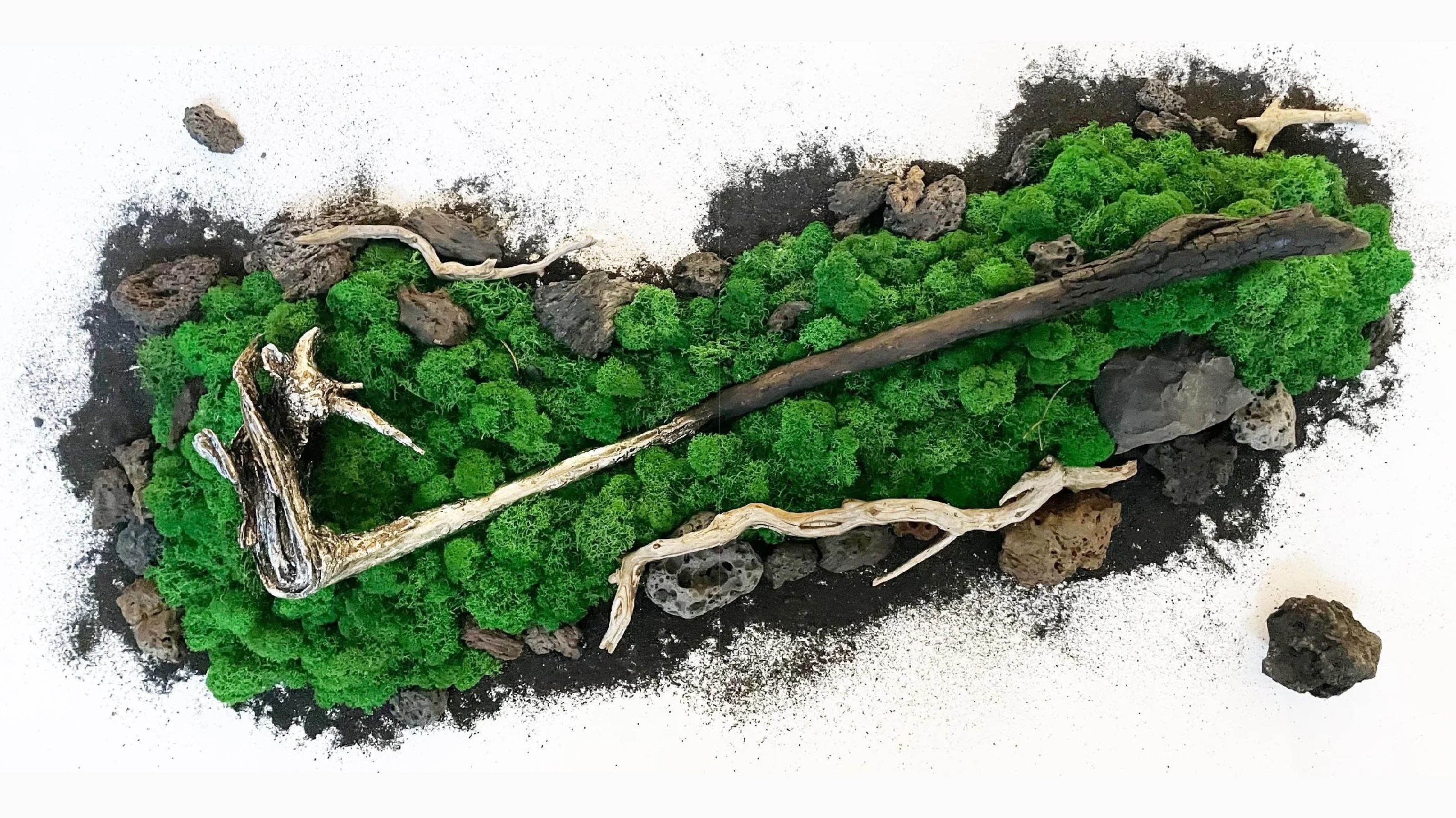 The Funeral of the Axe: driftwood axe on moss, lava stones and black sand